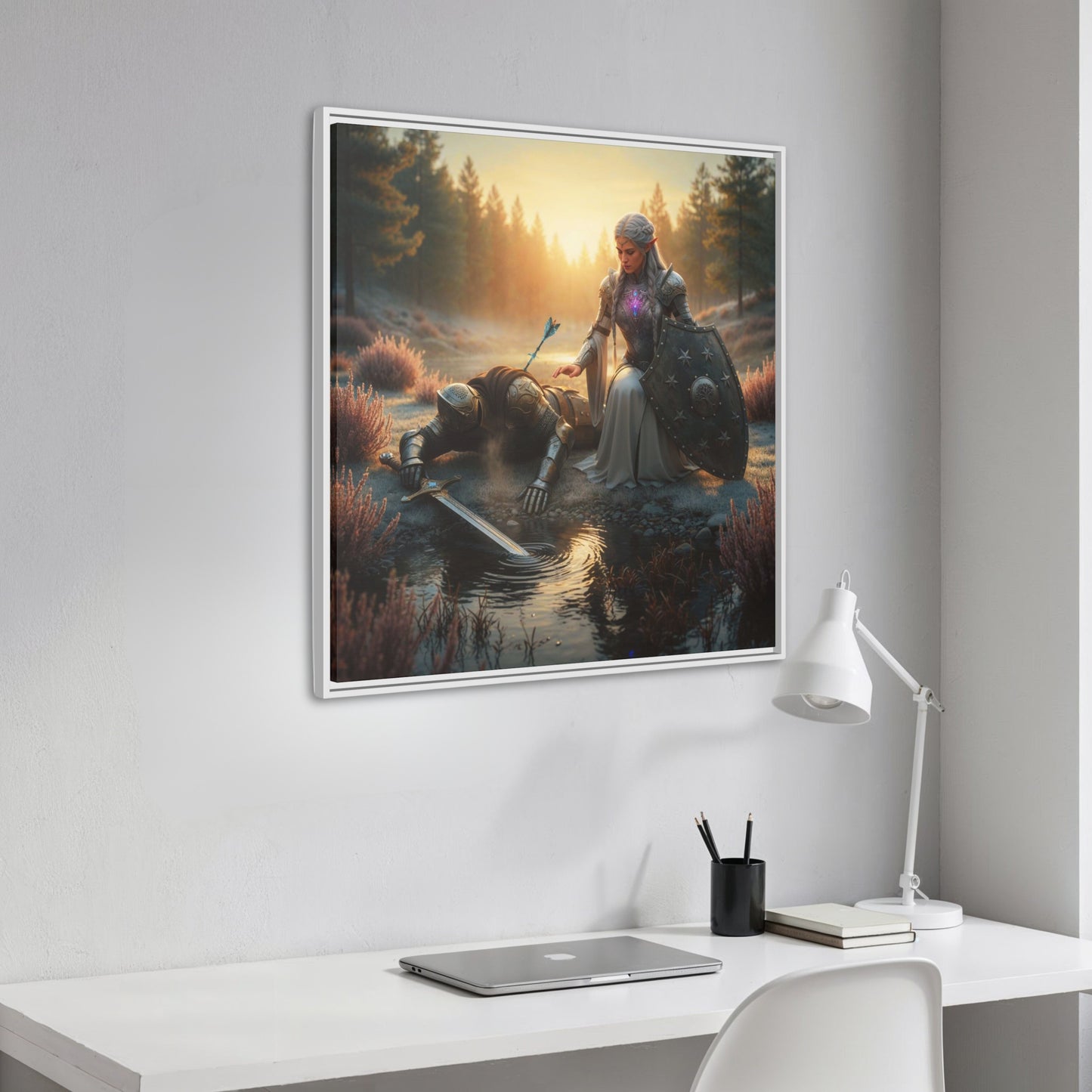 Angled white framed Lumera and fallen Knight forest scene from Chapter 1 hanging above a clean white workspace with laptop and lamp.