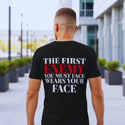 Black organic tee back quote, ENEMY in red, modern concrete-and-glass city backdrop; text crisp and legible.