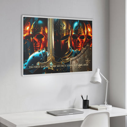 Angled white framed ‘The first enemy wore my face. I did not look away.’ knight and skulls canvas hanging above a clean white workspace with laptop and lamp.
