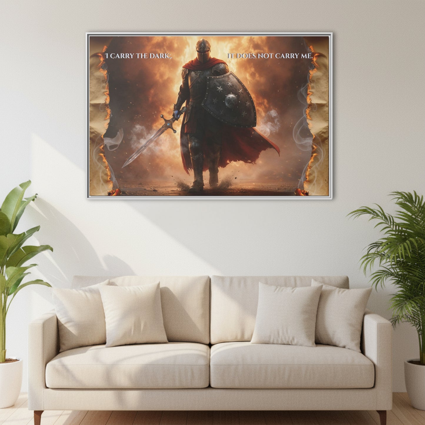 Horizontal knight walking through fire framed canvas with the quote ‘I carry the dark; it does not carry me’ hanging above a white sofa in a bright living room.