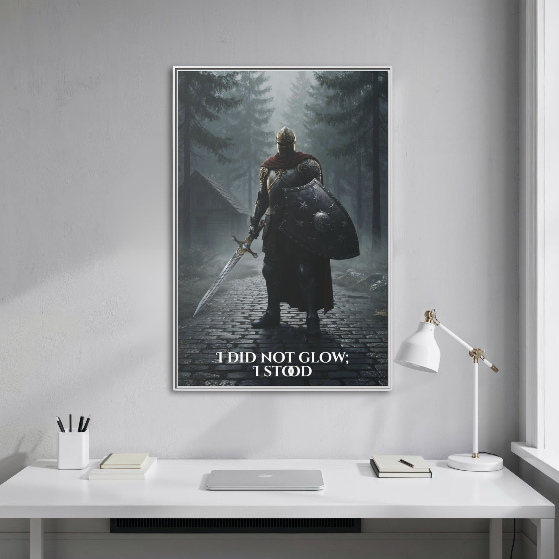 Vertical knight-in-forest canvas with the quote ‘I did not glow; I stood’ hanging straight-on above a minimalist white desk.