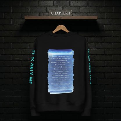 Chapter 1 black sweatshirt hanging on a rail against a dark brick wall, back design featuring the blue scroll from the Scroll of Lost Paths and the line “Then I Stepped Anyway”.
