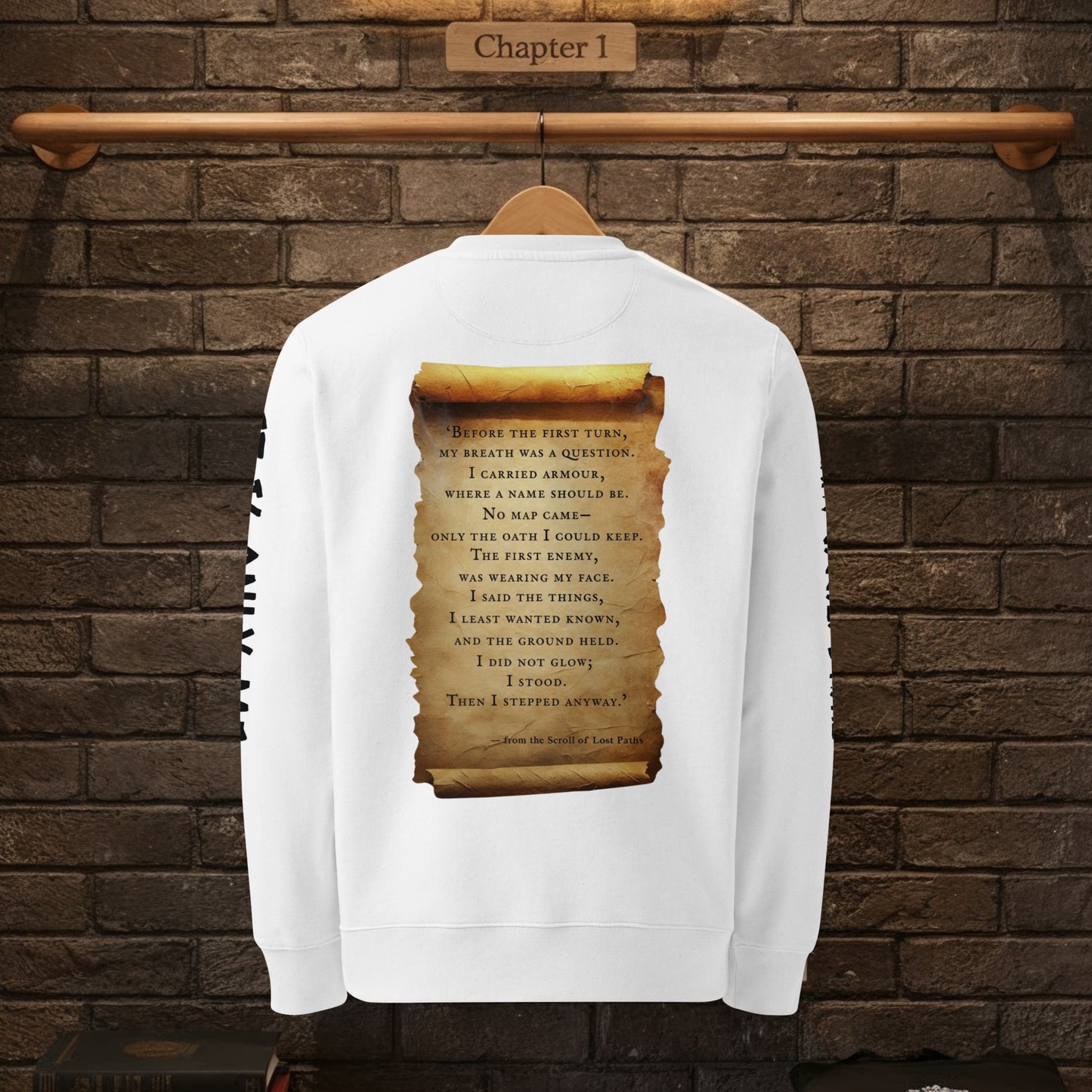Back view of white sweatshirt on hanger against brick wall, featuring large parchment scroll quote from The Knight’s Path.