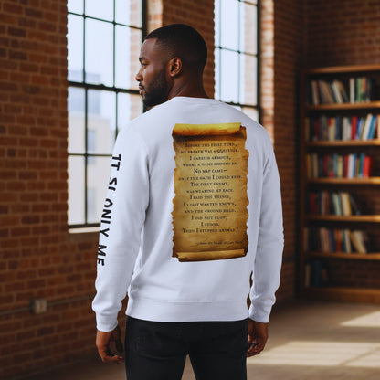 Man in a brick loft library facing away, showing the parchment scroll quote and “IT IS ONLY ME” sleeve text on a white sweatshirt.
