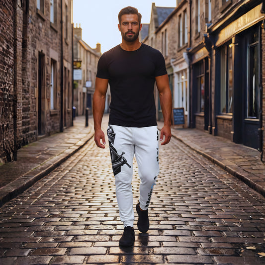 Adrian walking down a cobblestone old-town street at golden hour in white Motiv8 Collections Knight Armor joggers and a black T-shirt, frontal view of the knight illustration on the leg.