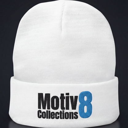 White Motiv8 Collections embroidered beanie on dark studio background, minimalist winter streetwear close-up