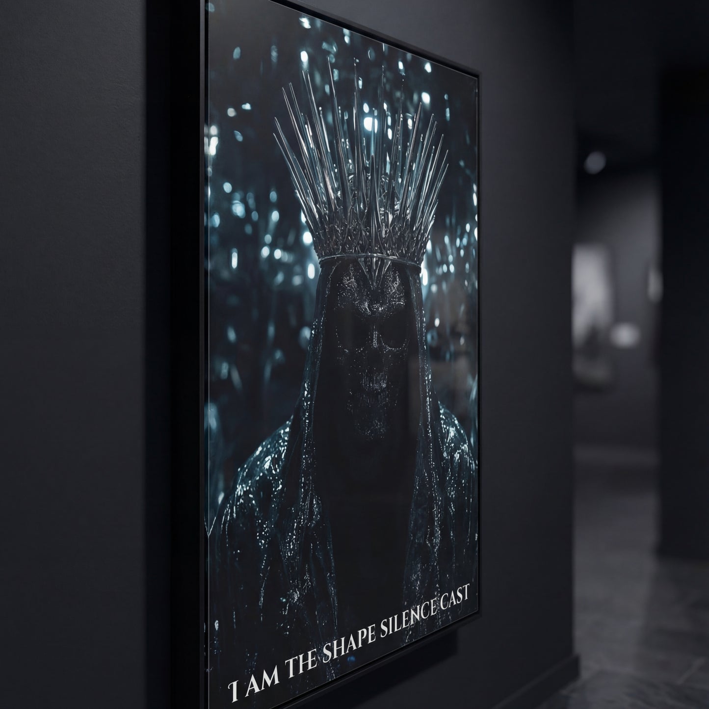 Side-angle close-up of the “I Am The Shape Silence Cast” black-framed poster in a moody gallery hallway, highlighting the spiked crown and shadowed skull figure.