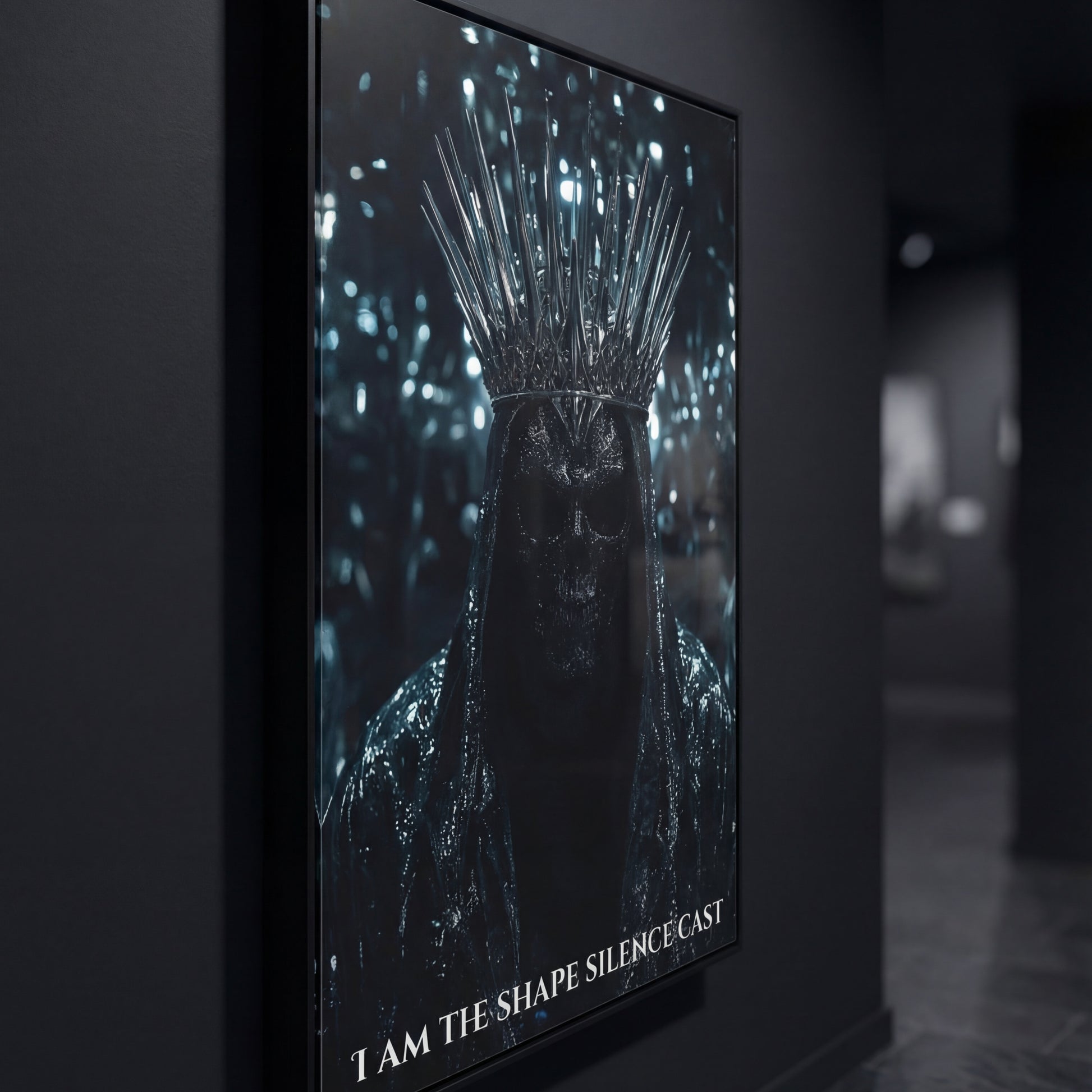 Side-angle close-up of the “I Am The Shape Silence Cast” black-framed poster in a moody gallery hallway, highlighting the spiked crown and shadowed skull figure.